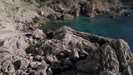 Rock-pool-and-sheltered-bay-on-coast-of-tropical-island-in-summer-sun