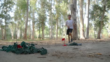 A-boy-runs-towards-his-toy-army-men-excited-to-play-at-the-park