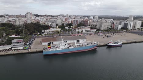 Aerial-tracking-docked-Work-ship-in-industrial-port-of-Huelva,-Spain