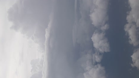 Vista-Vertical-Del-Cielo-Mientras-Vuela-Sobre-Un-Paisaje-De-Nubes-Esponjosas-Durante-El-Día,-Vista-Aérea-Sobre-Las-Nubes-Y-El-Concepto-De-Inspiración-Del-Cielo,-Paisaje-De-Nubes-De-Fondo-Natural