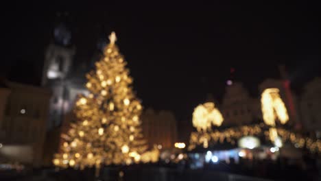 Christmas-market-in-city,-tree-blurry-lights-soft-focus-panning-right-view