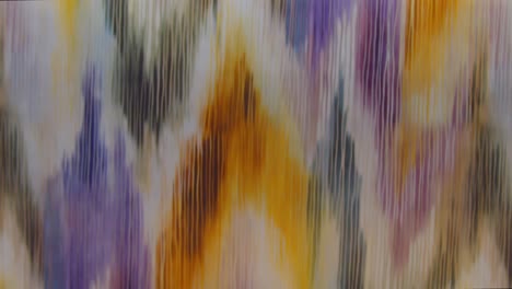 Detail-of-colored-textile-moving-vertically