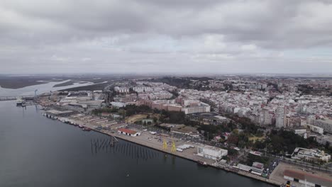 Aerial-Flying-Over-River-Odiel-With-View-Of-Logistics-Terminal-Port-In-Huelva-And-Townscape-In-Background