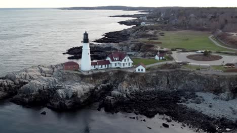 Orbit-aerial-around-Portland-Head-Lighthouse-during-winter-time-in-Maine