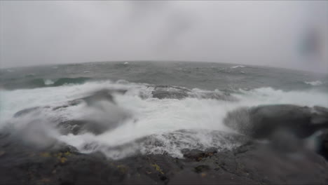 Slow-motion-shot-of-large-waves-breaking-on-the-rocky-shoreline-of-Lake-Superior