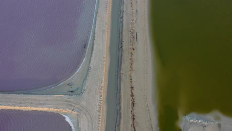 aerial-top-down-view-of-pink-and-green-lakes-separated-by-sandbar-in-Las-Coloradas-Mexico