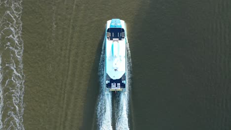 Top-down-drone-shot-tracking-City-Cat-Boat-driving-along-Brisbane-River