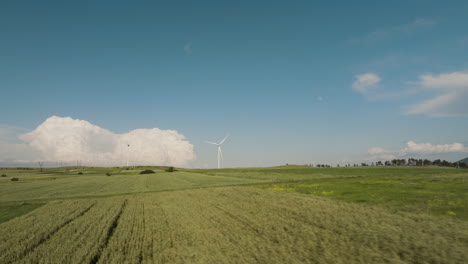 Gori-wind-generator-farm-in-green-fields-of-Georgia-below-blue-sky