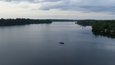 Aerial,-small-fishing-boat-on-a-huge-lake-in-the-United-States-on-an-overcast-day