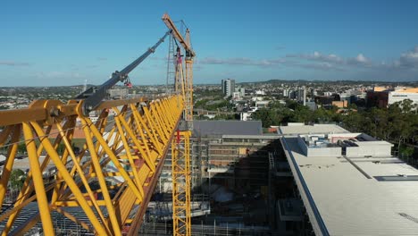 Drone-shot-of-yellow-crane-in-contraction-site