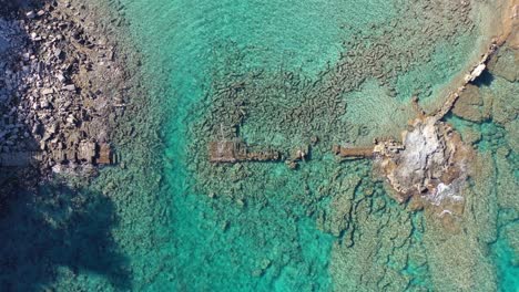 Top-Down-Aerial-View-of-Remains-of-Ancient-Bridge-Above-Lagoon-of-Mediterranean-Sea-at-Turkish-Coastline