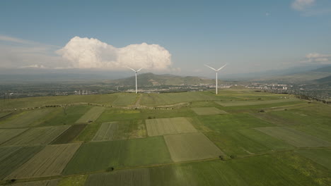 Wind-turbine-generators-above-picturesque-field-countryside,-Georgia