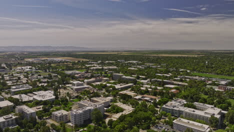 Davis-California-Aerial-v1-panoramic-view-drone-flyover-uc-davis-campus-area,-a-renowned-public-land-grant-research-university-on-a-sunny-day-with-blue-sky---Shot-with-Mavic-3-Cine---June-2022