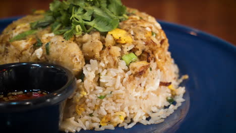 Close-up-of-restaurant-dish-Crab-Fried-Rice-topped-with-cilantro,-slider-4K