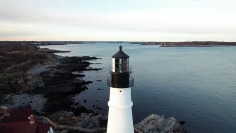 Parallax-of-Portland-Head-Lighthouse,-establishing-aerial-in-Portland-Maine