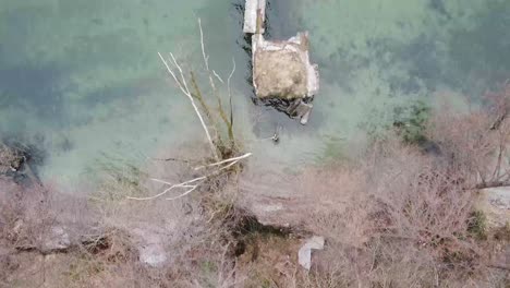 Cinematic-top-down-footage-of-Broken-Seaplane-Bridge-in-Italy,-Ticino-River