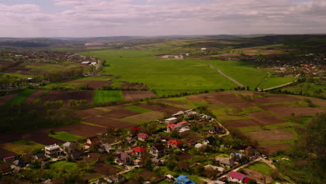 Magdacesti,-Republic-of-Moldova,-village-and-fields-Aerial-Shot-overseeing-horizon