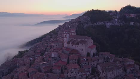 Magical-sunrise-at-mountain-village-Artena-with-mist-in-Sacco-valley,-aerial