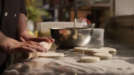 Man's-hands-roll-out-the-dough-for-dumplings