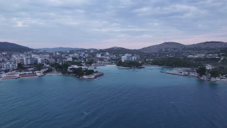 Aerial-panoramic-view-of-Ksamil-Coastline,-Turquoise-water-bay-and-Waterfront-resorts,-Albania