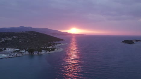 Gorgeous-warm-sunbeam-over-calm-sea,-fire-sunset-at-Ksamil,-Albania