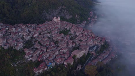 Touristic-mountain-town-Artena-with-mist-in-valley,-Italy,-aerial
