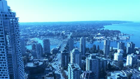 Vancouver-tallest-residential-building-overlooking-West-End-Burrard-street-bridge-Kitsilano-harbor-science-world-Grey-west-point-UBC-campus-across-English-Bay-residential-home-towers-and-condos