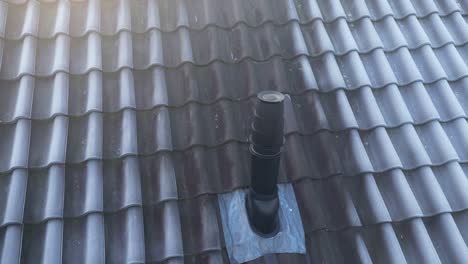 Close-up-of-furnace-roof-exhaust-vent-on-residential-house-rooftop