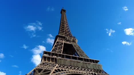 Famous-Eiffel-Tower-Towering-Against-Blue-Sky-In-Paris,-France