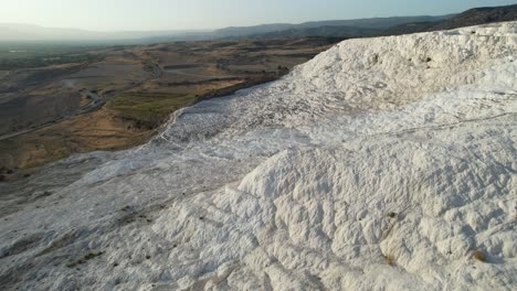 Aerial-View-of-Pamukkale,-Turkey,-White-Travertine-Hills-and-Landscape,-Drone-Shot
