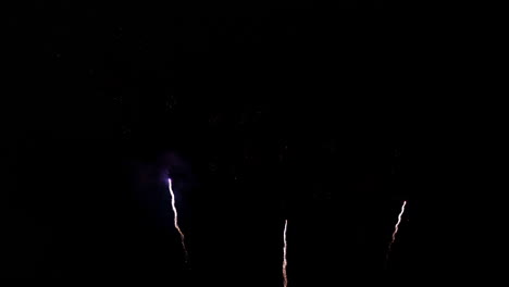 White-streaks-of-light-explode-into-colorful-fireworks