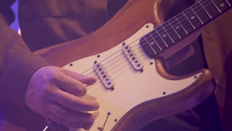Right-hand-of-band-man-playing-electric-guitar-with-pick-slowly,-Close-up-hands-shot