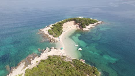 Aerial-pullback-from-Twin-Islands-in-the-turquoise-Colored-water-in-Ksamil,-Albania