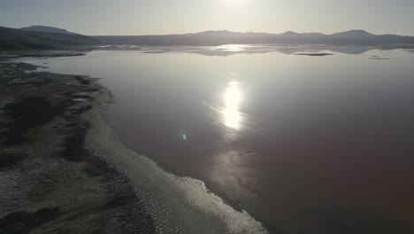 Sun-Reflects-on-Laguna-Colorada,-Bolivia,-Altiplano-High-Land,-Borax-Islands,-Salt-Flat,-Travel-and-Tourism-Destination-in-South-America
