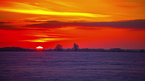 Dawn-Timelapse-of-red-sky-turning-into-orange-as-sun-shines-in-the-sky-and-crosses