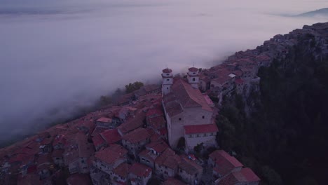 Holy-church-building-on-top-of-mountain-with-mist-in-valley-during-sunrise