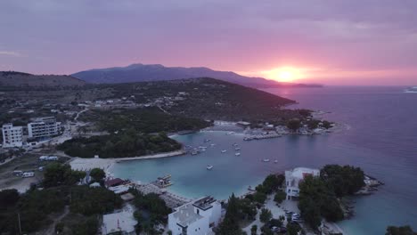 Aerial-view-of-Turquoise-colored-bay-of-water,-Touristic-Coastline-of-Ksamil-at-Sunset,-Albania