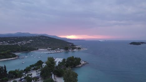 Aerial-Panoramic-view-of-the-scenic-turquoise-coastline-of-Ksamil-during-sunset,-Albania