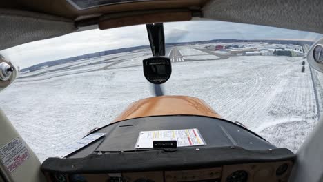 POV-inside-light-airplane-cockpit-landing-on-small-airport-strip-during-winter