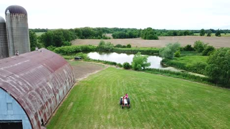 Aerial-drone-shot-of-tractor-in-a-farm