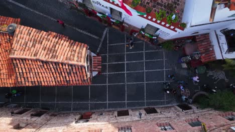 Aerial-view-above-people-and-cars-on-the-streets-of-Taxco-de-Alarcon,-Mexico