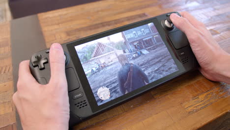 Close-up-of-playing-Red-Dead-Redemption-2-on-a-Steam-Deck-handheld-video-game-system-while-resting-it-on-a-table