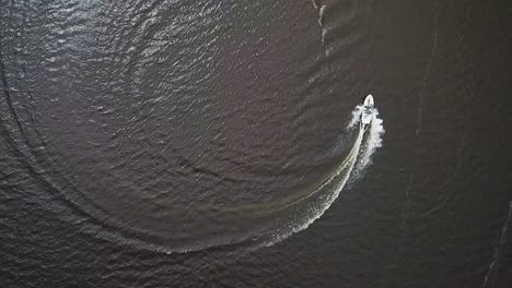 Drone-shot-of-a-speeding-boat-in-an-urban-lake
