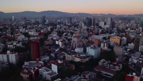 Dynamic-dramatic-cinematic-aerial-drone-establishing-shot-of-Mexico-City-at-sunset