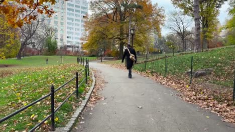 Elderly-well-dressed-gentleman-walking-through-Central-park-on-cold-autumn-morning