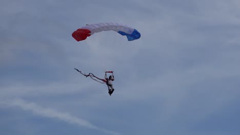A-skydiver-arrives-at-the-target-landing-area-at-Wings-over-Houston-Airshow-in-2021
