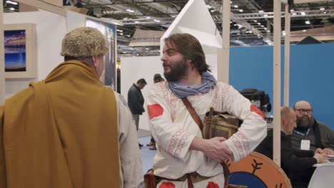 Folkloric-men,-wearing-traditional-viking-clothes,-tourism-trade-show,-Madrid,-Spain