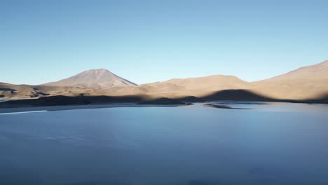 Lagunas-Route,-Aerial-Above-Bolivian-Blue-Lagoon,-Rock-Mountain-Formations,-Surreal-Shore-near-Atacama-Desert,-South-America-Travel-and-Tourism
