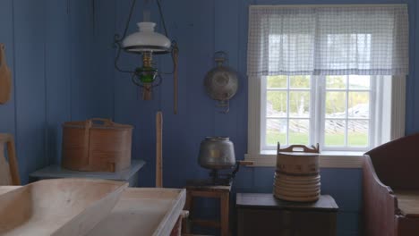 Pan-shot-inside-a-traditional-Norwegian-wooden-cottage-kitchen,-showcasing-vintage-equipment-and-rustic-charm