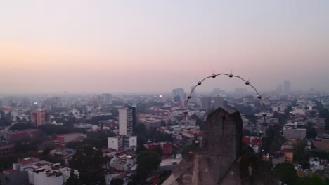 Long,-dynamic-wide-pivoting-drone-shots-of-massive-Jesus-status-towering-over-Mexico-City-at-sunset,-featuring-Parroquia-del-Purism-Corazon-de-Maria-and-buildings-in-the-back